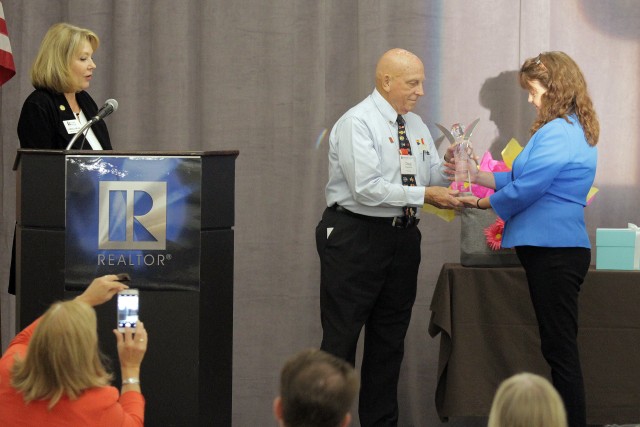 Arizona REALTORS® CEO Michelle Lind (left) announces Doug Groppenbacher as recipient of the 2016 Community Outreach Individual Award as presented by Director of Association Relations Monica Schulik.